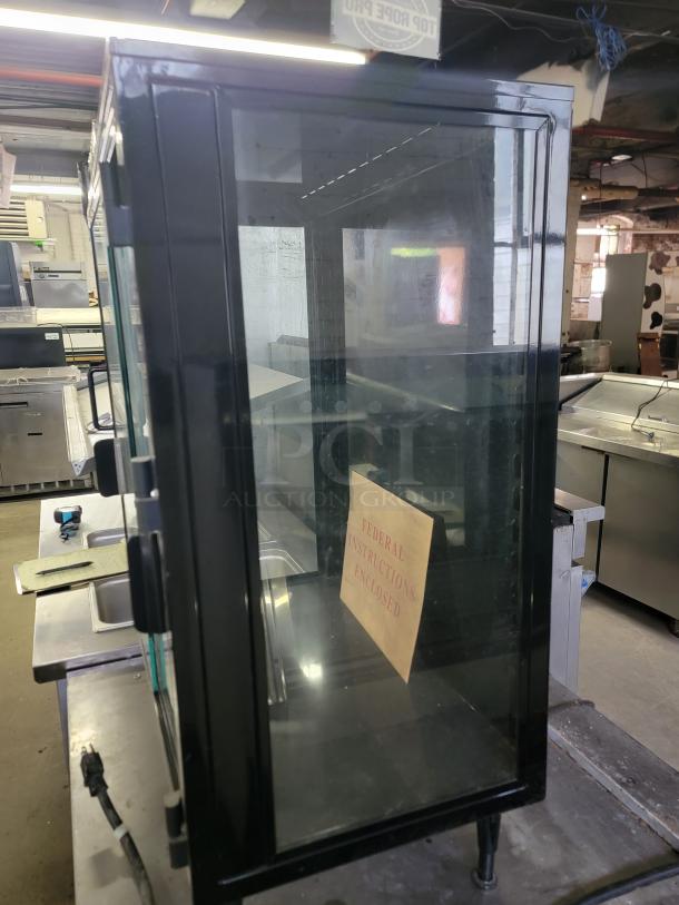 Federal Industries SB28SS lighted display case with a sleek black frame, clear glass doors, and included instructions. Perfect for cafes.