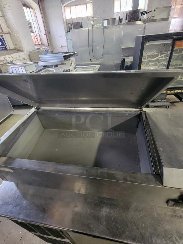 Avantco 40" refrigerated countertop prep rail with open stainless steel lid, showcasing spacious interior for efficient food prep.