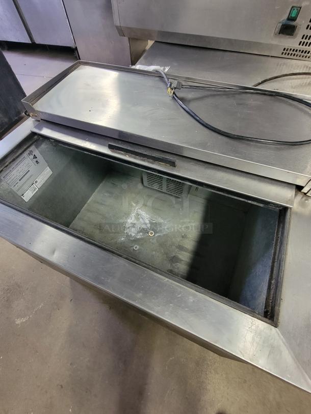 Beverage-Air SF34HC-B bottle cooler, stainless steel, shallow well, lightly used, interior label visible, for bars or cafes.
