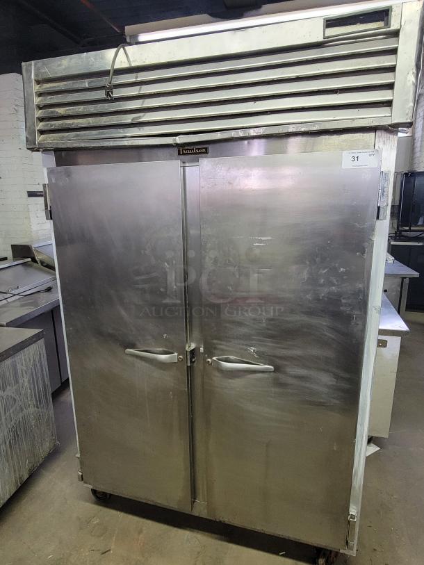 Traulsen G22010 commercial 2-door reach-in freezer, stainless steel, visible wear, ideal for food service businesses.