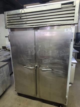 Traulsen G22010 commercial 2-door reach-in freezer, stainless steel, visible wear, ideal for food service businesses.
