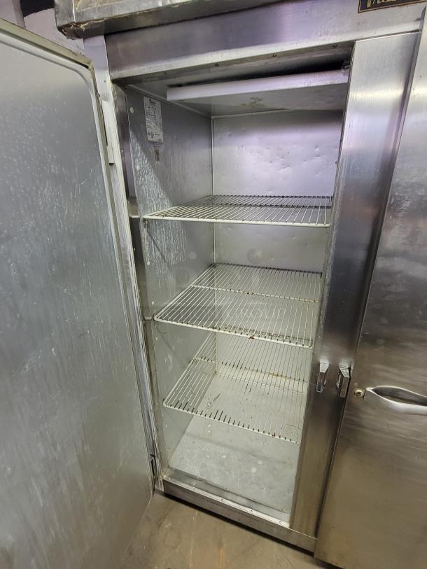 Traulsen Commercial Freezer G22010, 2-door, spacious interior, three wire shelves, steel exterior, ideal for food service.
