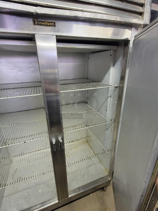 Traulsen G22010 two-door commercial reach-in freezer, stainless steel, used condition, visible shelving, ideal for restaurants.