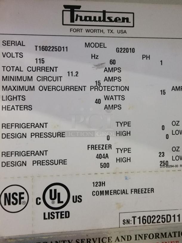 Traulsen Commercial Freezer model G22010 label showing specs: 115V, 60Hz, NSF & UL listed, uses 404A refrigerant.