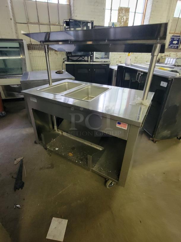 SECO SELECT BST-44 mobile heated serving cart, stainless steel, dual food pans, shelf, on wheels, American flag label.