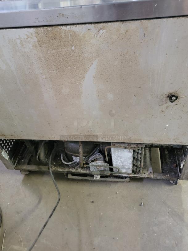 True TUC-36-34 commercial undercounter refrigerator in used condition, showing visible wear and exposed mechanical parts.