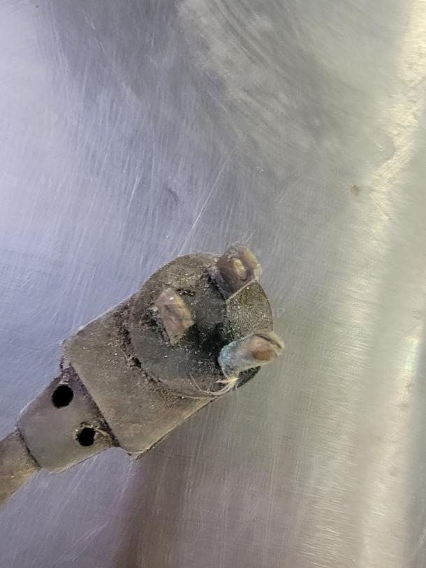 Close-up of a power plug for the True TUC-36-34 commercial refrigerator, showing wear and dust accumulation.