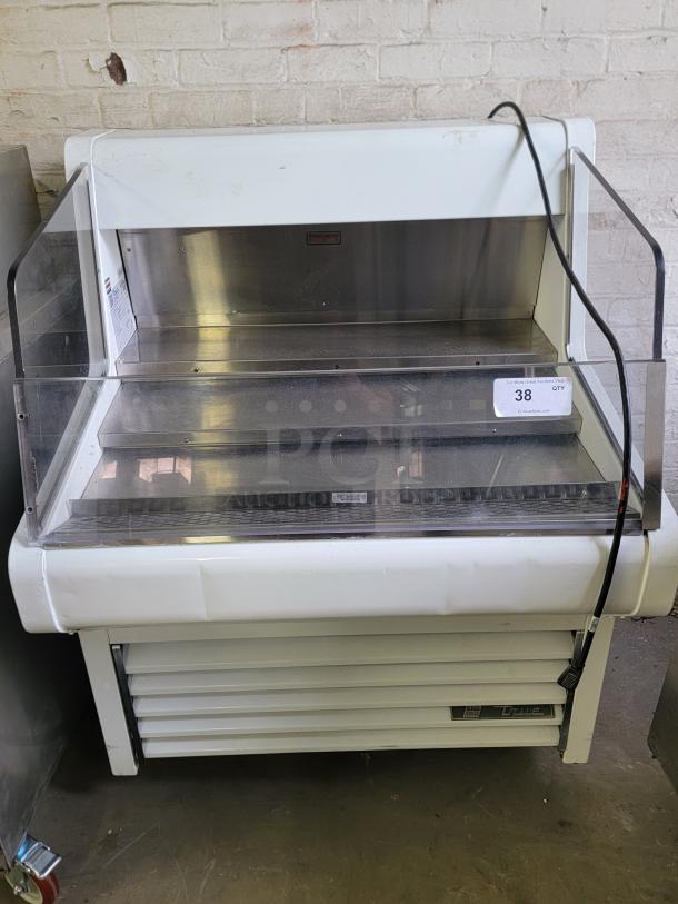True THAC-36 refrigerated display case with glass front, ideal for bakeries or cafes. White exterior, good condition. Auction tag visible.