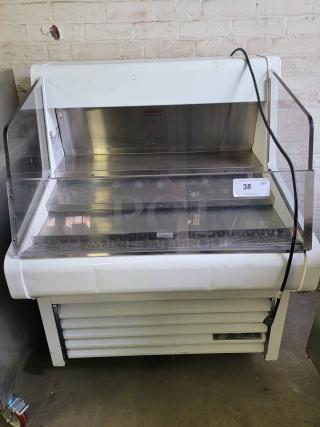 True THAC-36 refrigerated display case with glass front, ideal for bakeries or cafes. White exterior, good condition. Auction tag visible.