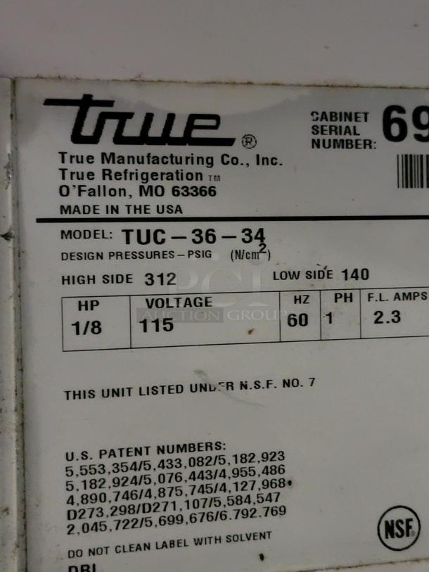 True TUC-36-34 undercounter refrigerator label, detailing model, voltage 115, and made in USA. Ideal for compact cold storage.