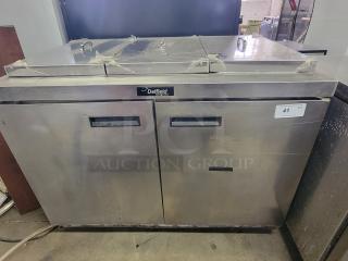 Delfield 2-door refrigerated prep table for commercial kitchens. Stainless steel, used condition, brand label visible.
