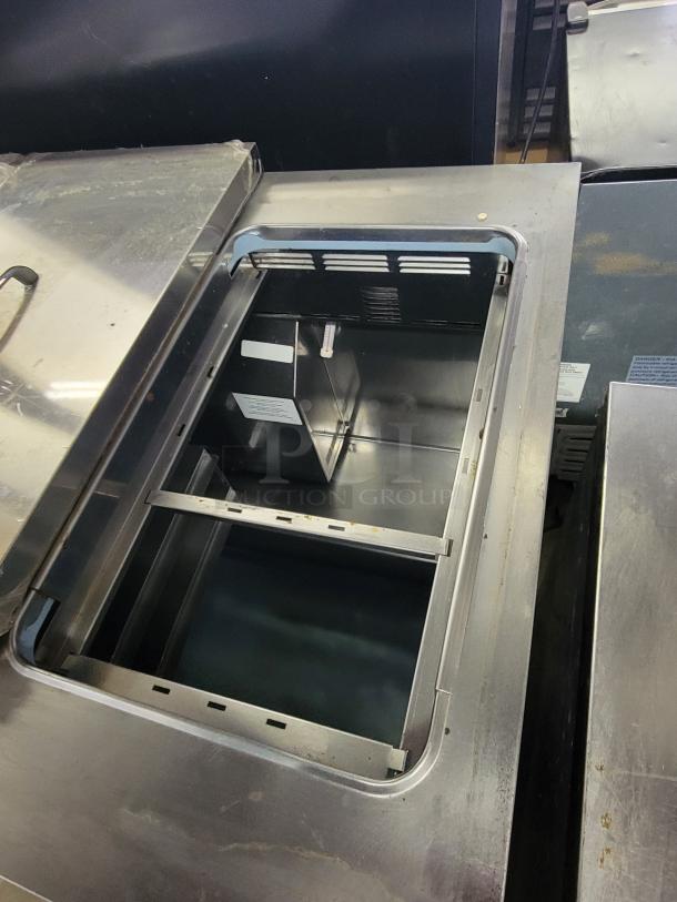Delfield 2-door refrigerated prep table, stainless steel, interior view, suitable for chilling ingredients.