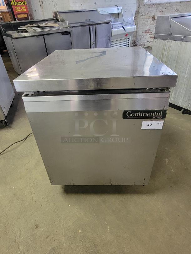 Continental SWF27 undercounter freezer, stainless steel, for commercial kitchens. Visible brand label, compact size, used condition.