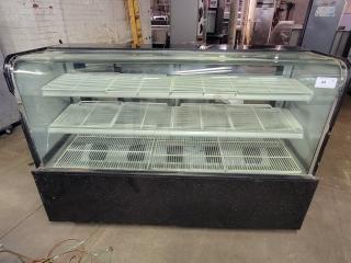 69" refrigerated display case with cracked side glass panels. Features interior shelving for chilled items. Make and model unknown.