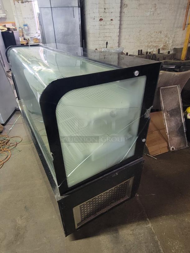 69" refrigerated display case with cracked side glass panels, black frame, and interior shelves for chilled items.