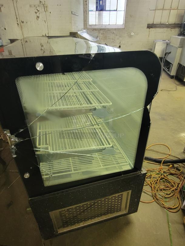 69" refrigerated display case, ideal for chilled items. Both side glass panels cracked, need repair or replacement.