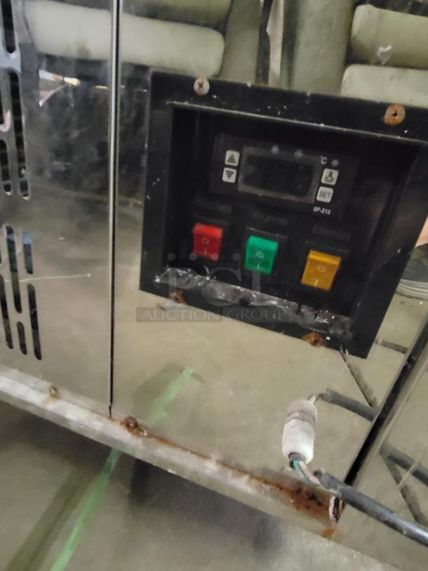 Refrigerated display case with digital controls; cracked side glass panels; unknown make and model; measures 69 inches.