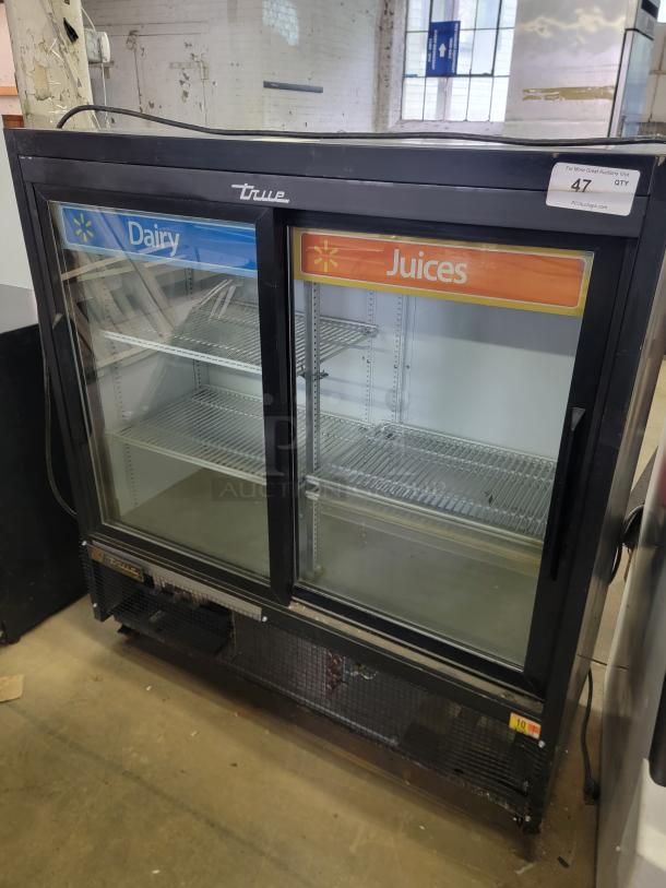 True GDM41SL48HC commercial refrigerator, two-door, labeled for dairy and juices. Excellent condition, ideal for retail use.