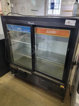 True GDM41SL48HC commercial refrigerator, two-door, labeled for dairy and juices. Excellent condition, ideal for retail use.