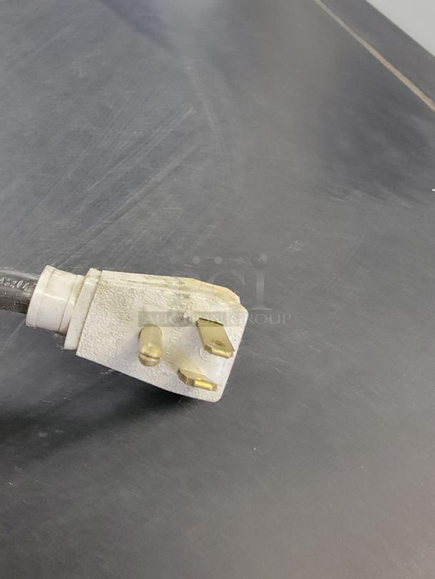 Close-up of a power plug for the True commercial refrigerator model GDM41SL48HC.