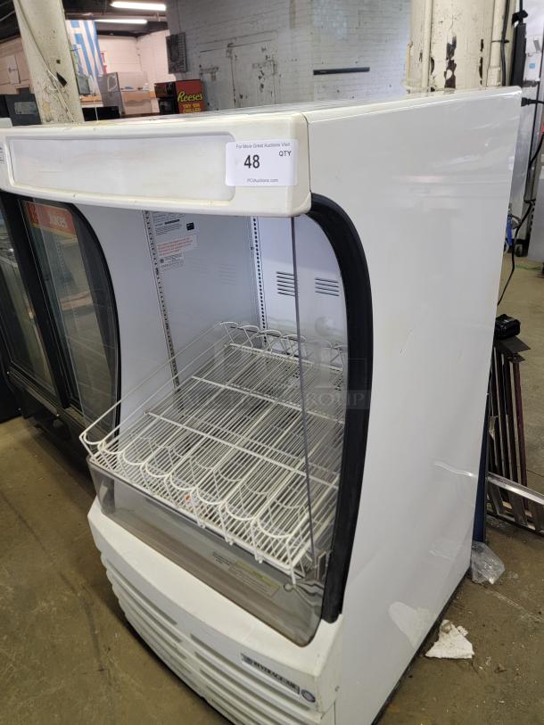 Beverage-Air BZ13-1-W open-air merchandiser, white, grid shelves, tag shows auction info. Ideal for cafes or stores. Good condition.