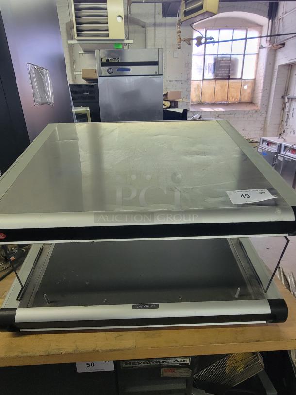 Hatco Glo-Ray GR2SDS-24 pass-thru food warmer in silver. Features a robust design with caution-hot label, suitable for restaurants.