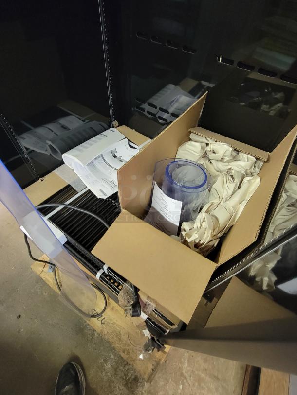 True Refrigeration CVM-27-HC display cooler, new scratch and dent condition, packaging includes manuals and accessories.