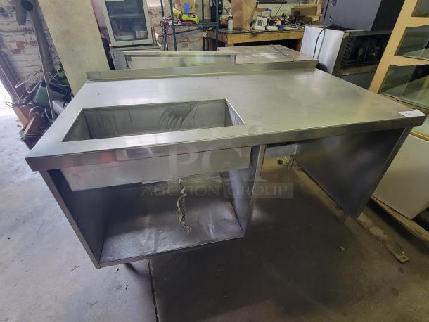 Delfield DWE-1.0 stainless steel work table with built-in hot food well, ideal for buffets. Sturdy, commercial-grade condition.
