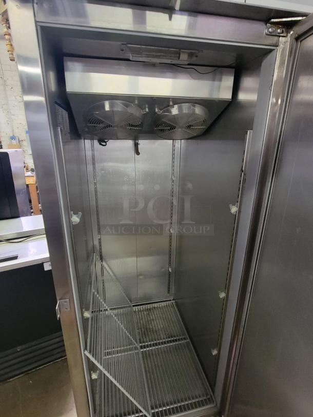 Norlake NX211SMS/8 commercial reach-in freezer. Single-door, stainless steel. Interior view with shelves. Ideal for businesses.