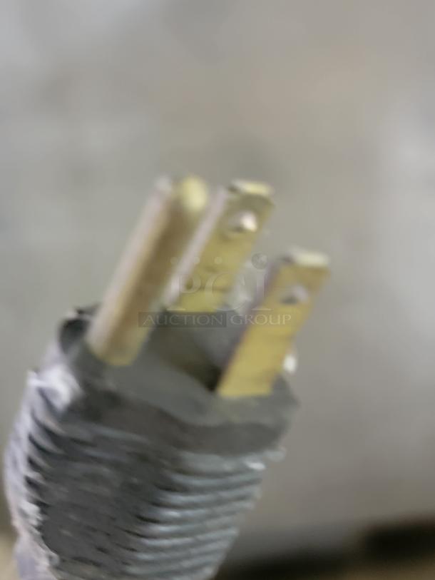 Close-up of a power cord plug, potentially for a Victory VR-1 refrigerator. The plug shows signs of wear.