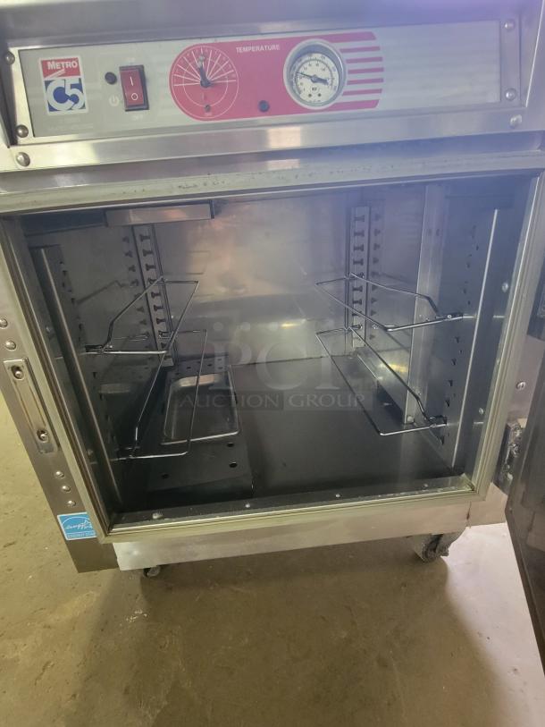 Metro C5 Series Heated Holding Cabinet, model C563-SFS-U, with adjustable racks and temperature controls, in good condition.