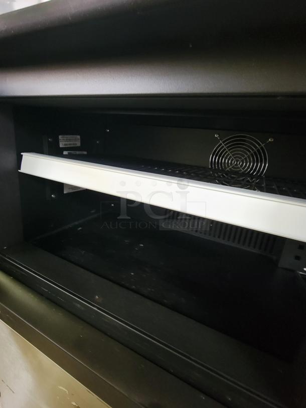 Brand new RMTLC DDF-90 refrigerated P.O.P. display, compact with minor scratches, ideal for showcasing cold items.