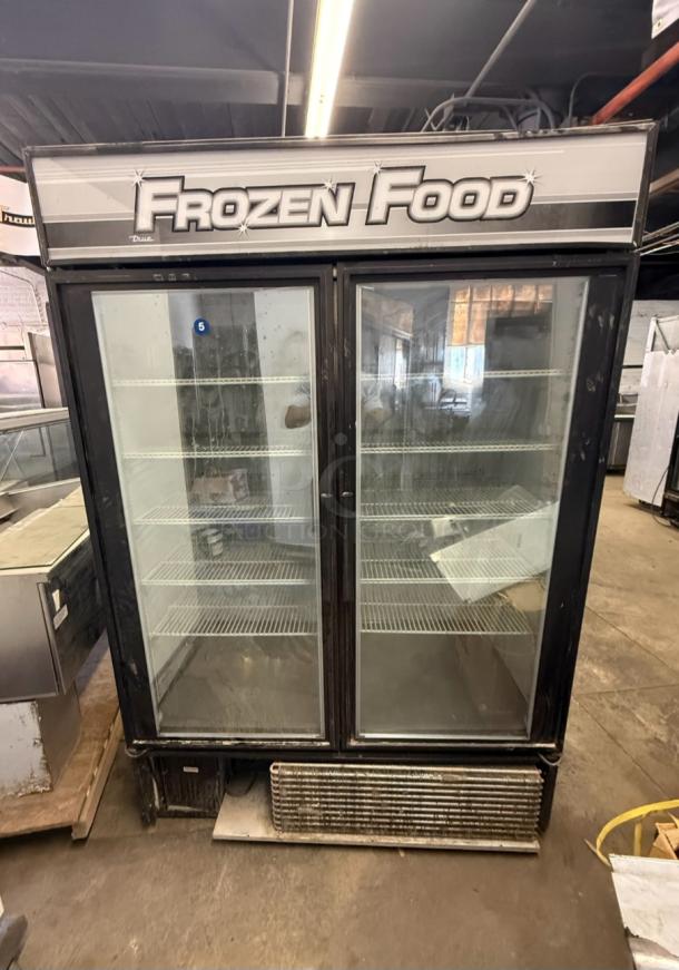 True GDM-49F 2-door glass reach-in freezer, commercial-grade, used condition, visible shelves, "Frozen Food" label.