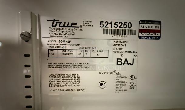 True GDM-49F model label showing specs: refrigerant R404A, voltage 115/208-230, 1 1/2 HP, NSF certified.