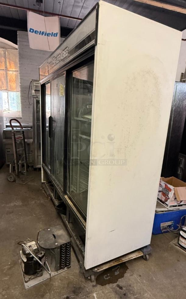 True GDM-69 three-glass door commercial refrigerator with sliding doors in used condition, suitable for retail display.