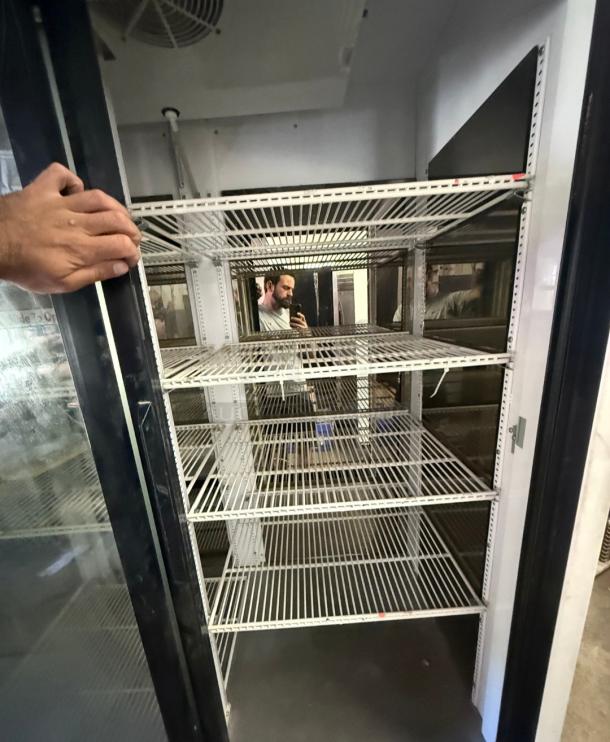 True GDM-69 commercial refrigerator with three sliding glass doors, spacious wire shelving, ideal for retail displays.