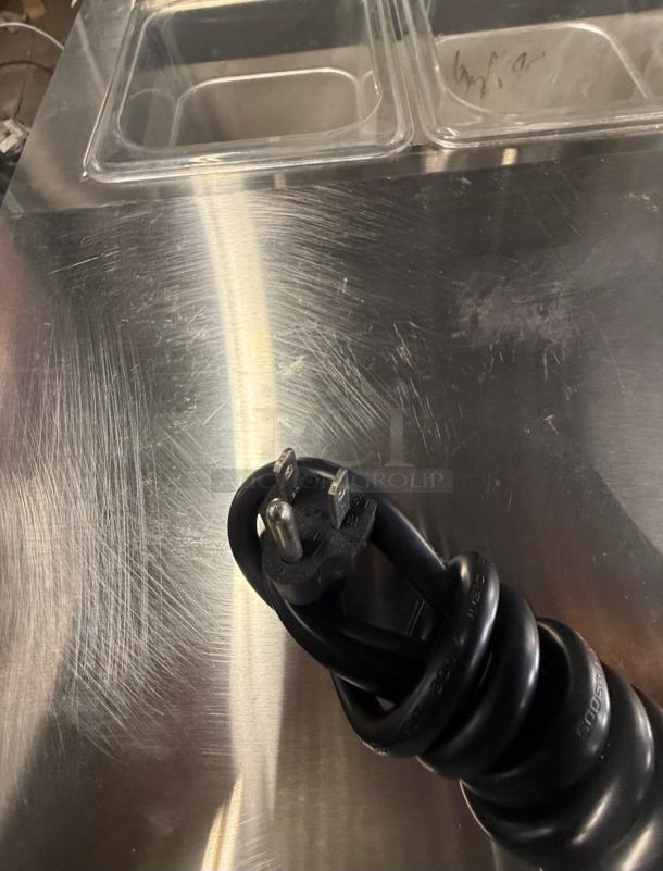 Artic Air ACP8SQ refrigerated prep rail, like-new condition, stainless steel surface with clear containers, ideal for restaurants.