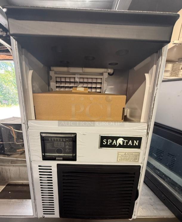 Spartan SUIM-68 Ice Maker. Compact, low-profile design, ideal for small businesses. Features control panel and Spartan branding.