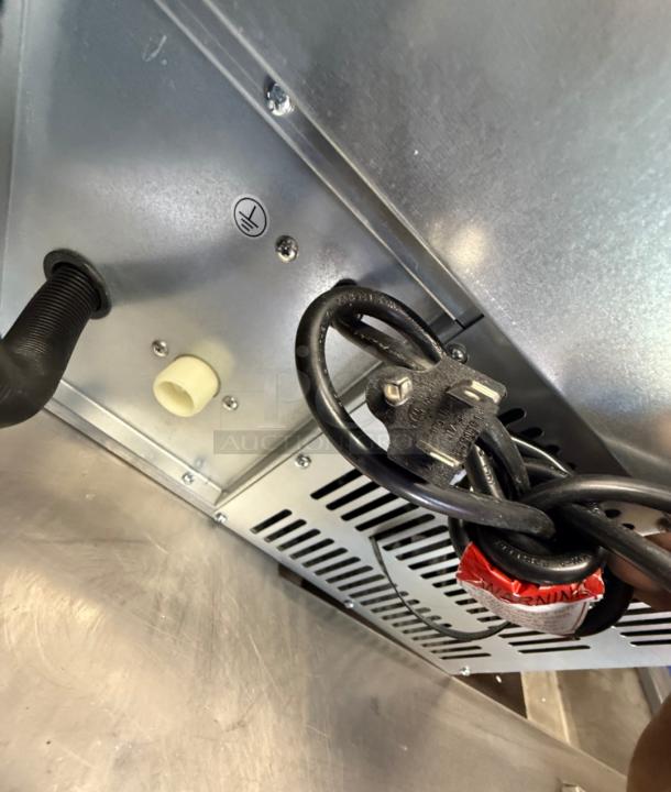 Spartan SUM-68 Ice Maker underside view with power cord and grounding symbol. Compact, ideal for cafes or offices.