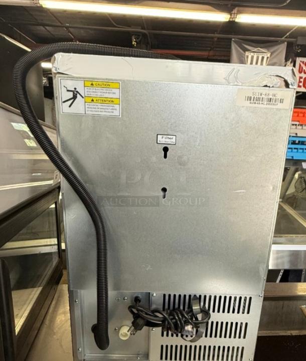 Spartan SUIM-68 ice maker rear view, showing caution label, filter slot, and power cord. Ideal for compact spaces.