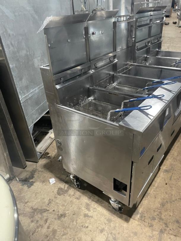 Pitco FG-SGH50 stainless steel 4-bay deep fryer. Includes basket hanger, fry baskets, oil filter, casters, and gas hose.