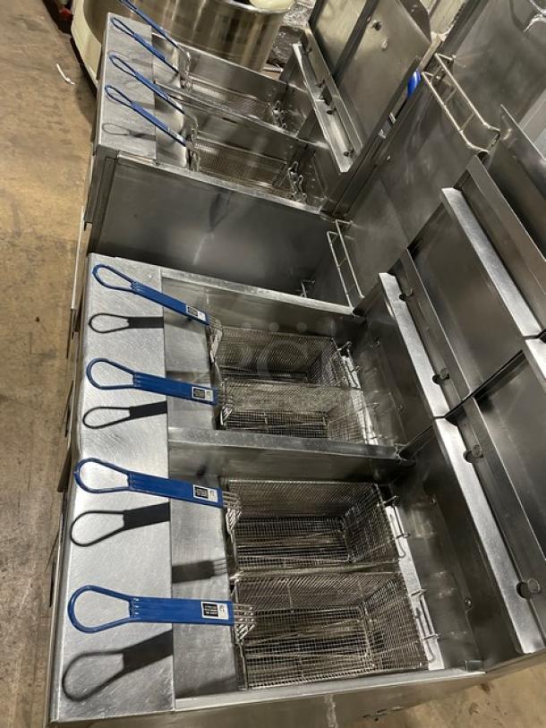 Pitco commercial stainless steel 4-bay fryer system, model FGSGH50. Includes basket hanger, fry baskets, oil filter, and blue gas hose.