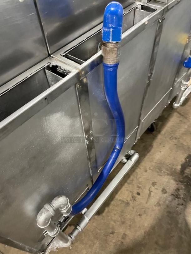Pitco FG-SGH50 commercial stainless steel four-bay fryer system with blue gas connection hose, basket hanger, and oil filter.