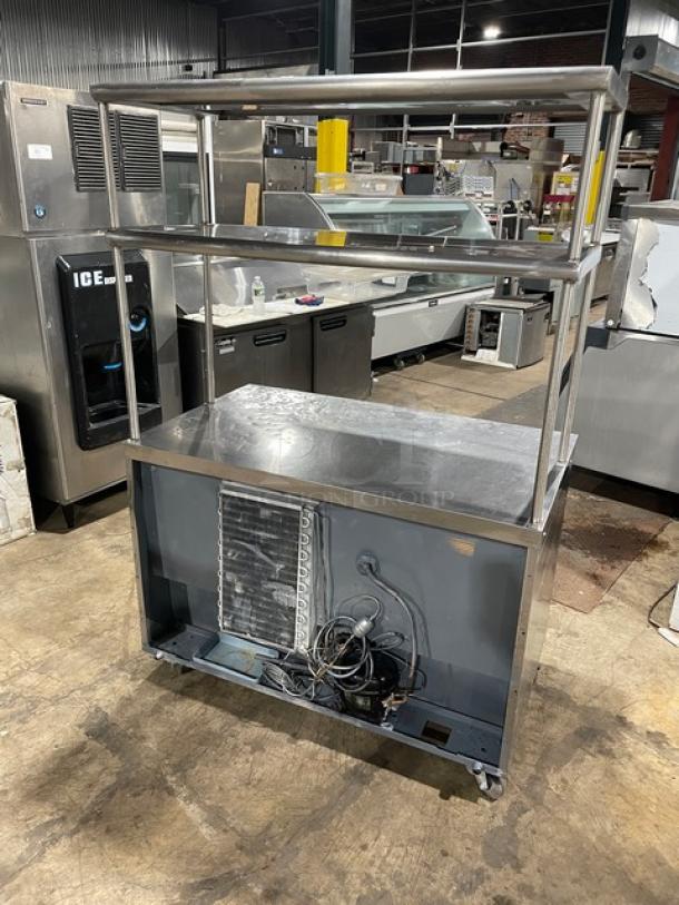 Delfield stainless steel 2-door refrigerated worktop table, model UC4048-STAR. Features double overhead shelf, poly coated wire racks, casters, and Energy Star certified. Serial number 1108152002465.