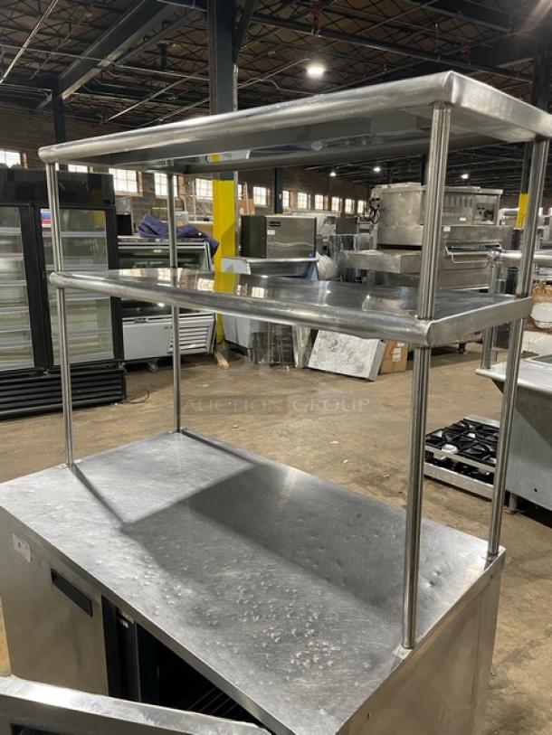 Delfield stainless steel 2-door refrigerated worktop table, model UC4048STAR, with double overhead shelf and poly-coated wire racks.