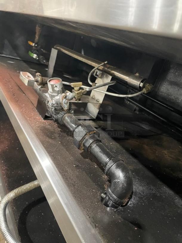 Custom stainless steel natural gas 4-well steam table, fancy sneeze guard, hotel pans, on legs, commercial use.