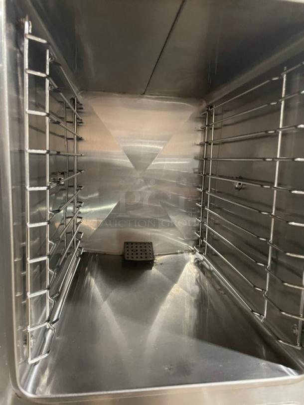 Interior of Southbend SX55EC stainless steel convection steamer, showing dual compartment with rack system. Clean condition.