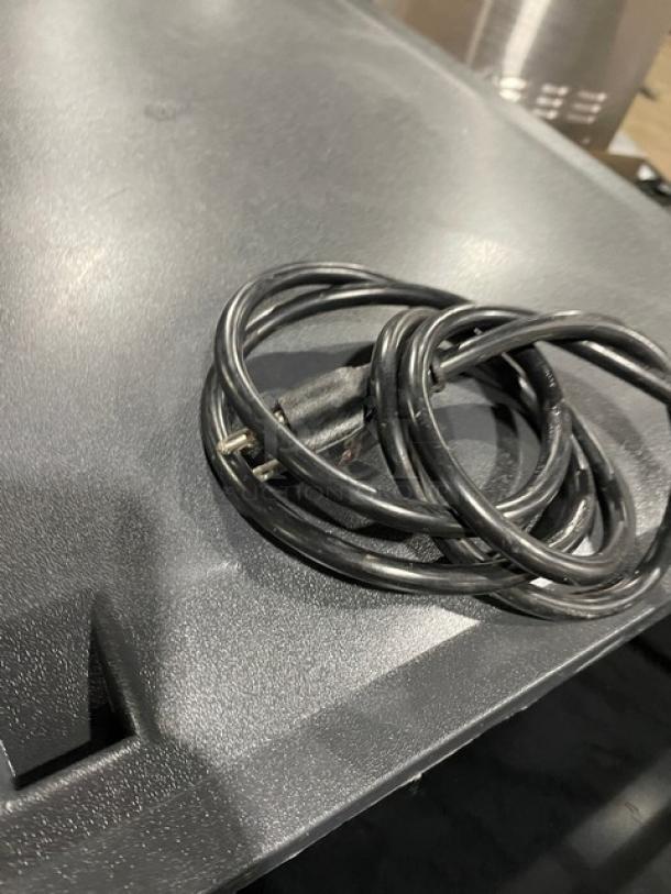 Coiled power cord placed on a dark surface, part of a Lancer Model 4500 beverage dispenser.