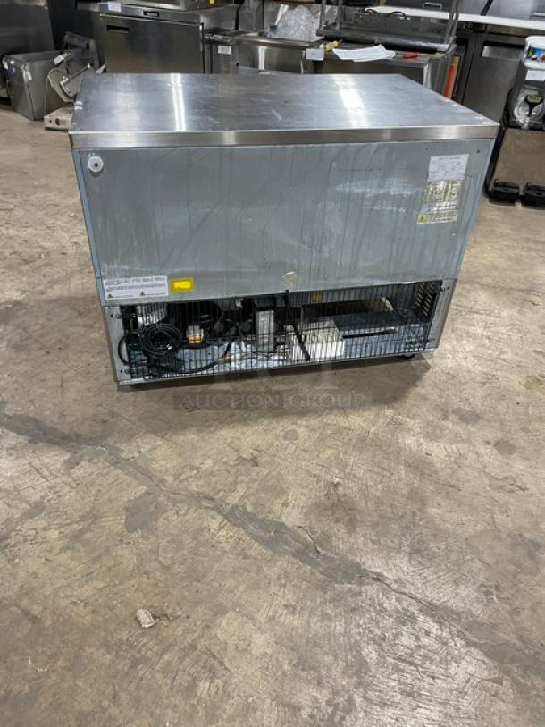 Entree UR48 stainless steel 2-door undercounter refrigerator, poly coated wire racks, 115V 1 Phase, on casters, model label visible.