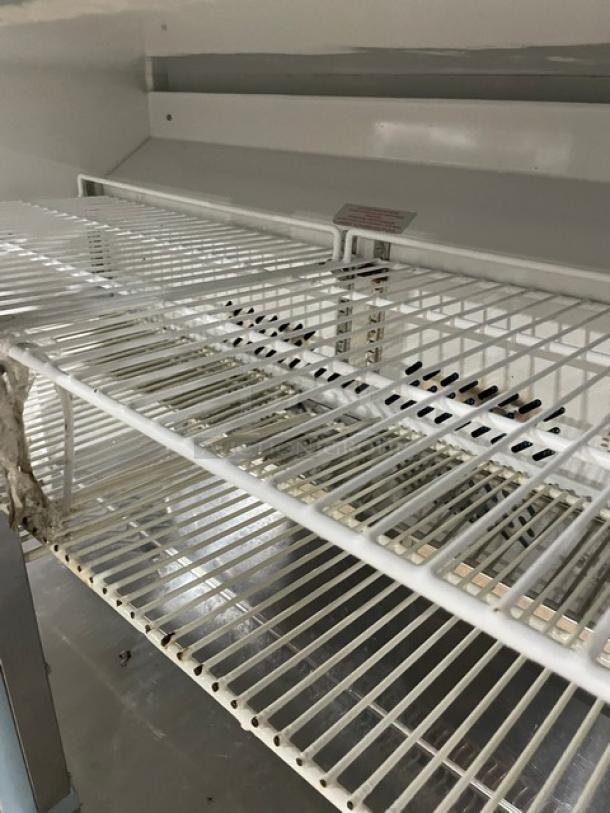 Entree UR48 undercounter refrigerator interior, showing poly coated wire racks. Model number and power details visible. Clean condition.